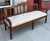 19th-century Swedish Gustavian settee features detailed hand-carving, including a bow motif on the crest rail and egg-and-...