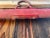 Early 20th Century Rustic Barn Yard Red Painted Wood Bar With Iron Hardware For Sale In Sacramento - Image 6 of 8