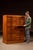 Tall oak index cabinet fitted with forty-eight uniform shallow drawers arranged in a tight grid, designed for systematic...