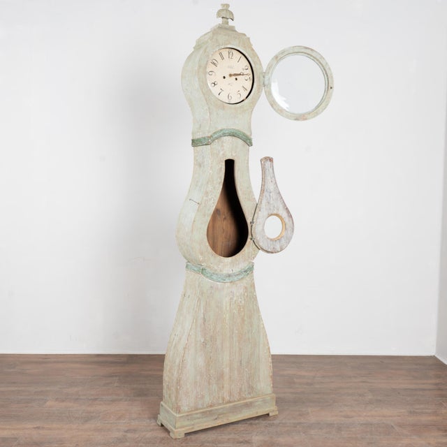 19th-century Swedish Mora grandfather clock with original pine long case. The original mint green painted finish has been...