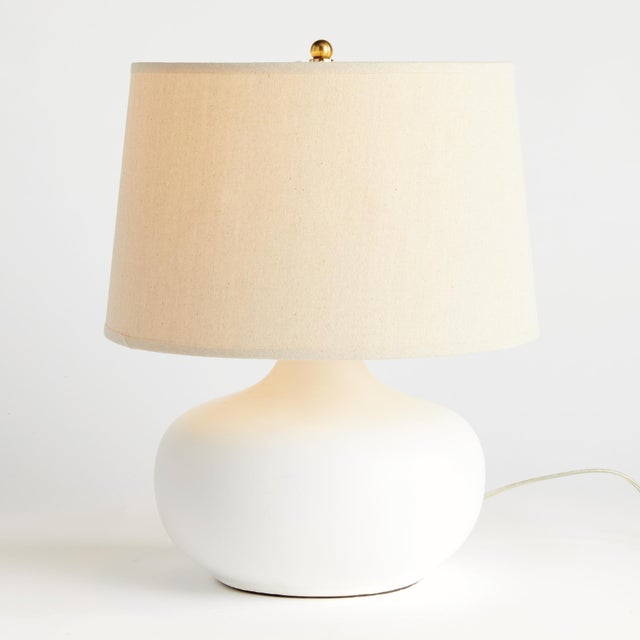This teardropshaped ceramic lamp is a modern take on a classic silhouette. The wellscaled shade and matte finish complete...