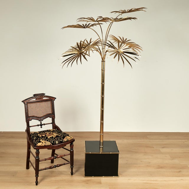 Lofty vintage Italian regency modern palm tree sculpture crafted in brass in stylized form and set in a black lacquer...