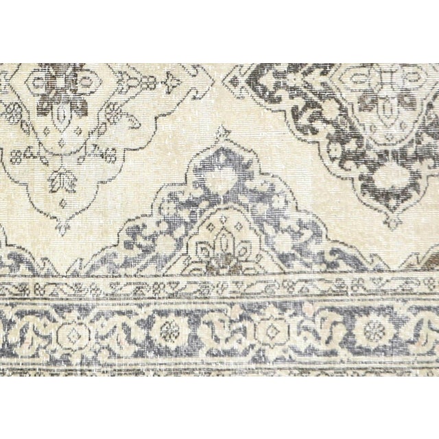 A vintage Turkish Oushak measuring 4'8" x 12'7", hand-woven with wool on wool foundation. This piece displays the region's...