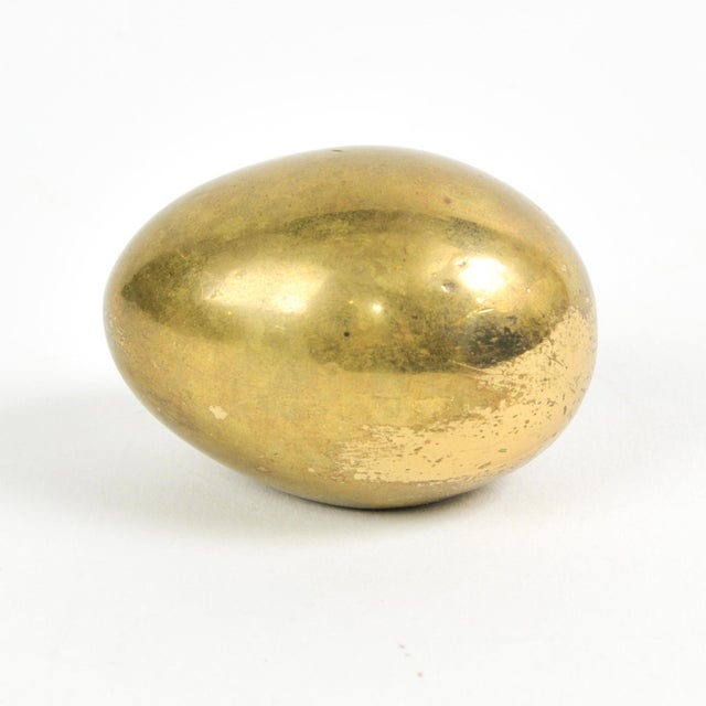 Artisanal solid brass original Aubock Paperweight in egg design. Measures ~ 2" x 1.5" (the larger of two sizes produced)....