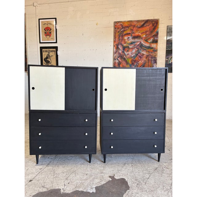 Vintage two-tone, black and white tall cabinets attributed to Paul McCobb. These cabinets (two available) feature...