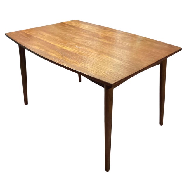 A refined dining table (also ideal as an elegant study desk) in Mid-Century Modern style, crafted in Scandinavian style in...