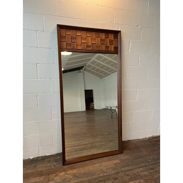 Vintage 1960s large walnut Brutalist style wall mirror by Tobago Furniture Co. The side of the mirror with the wood...