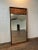 Vintage 1960s large walnut Brutalist style wall mirror by Tobago Furniture Co. The side of the mirror with the wood...