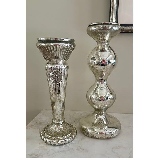 Beautiful and shiny set of two complementary vintage-looking candle sticks to brighten up your table or server! Taller...