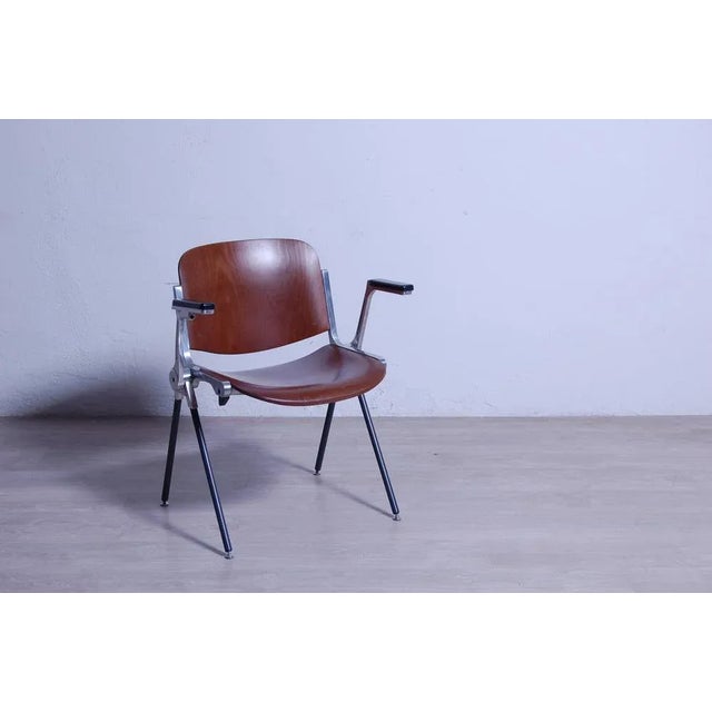 Elegant vintage design chair 1960s 70, iron structure with legs covered in plastic material. Sitting and back with wooden...
