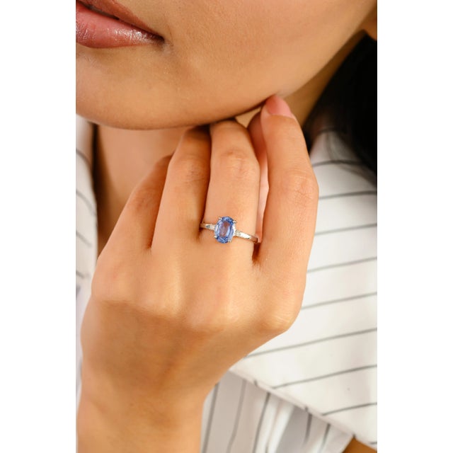 Elegantly minimal yet undeniably captivating, this 14k white gold ring showcases a brilliant 1.57 carat oval-cut blue...