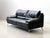 A generously sized three-seater sofa from the italian manufacturer natuzzi, upholstered in high-quality black genuine...