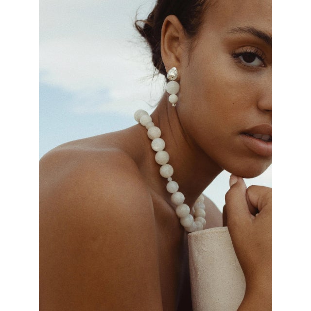 Meet the Blue Moon Earrings; Hand-carved studs that resemble the surface of the rocks, and round moonstone gemstones with...