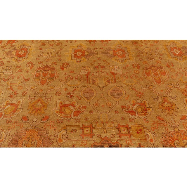 This majestic antique Turkish Oushak rug (size adjusted), handwoven circa 1900, is a testament to the enduring elegance of...