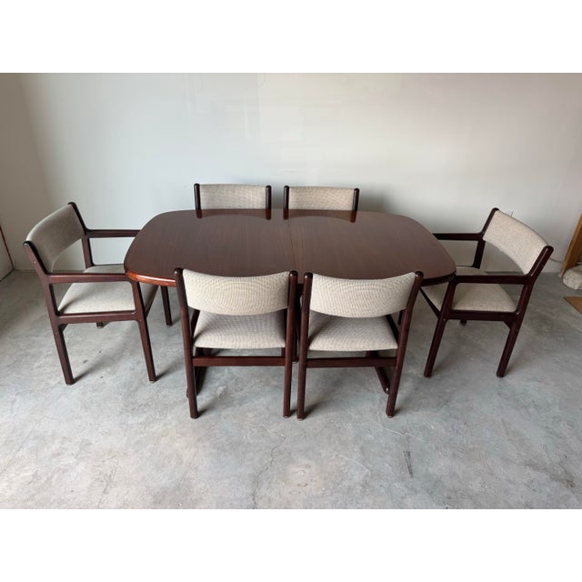 This refined set of six Mid-Century Danish Modern dining chairs was produced by J.L. Møller–Højbjerg, Denmark, a maker...