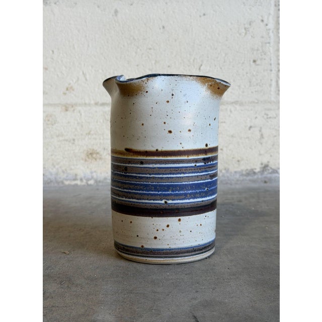 This exceptional studio pottery vase features a speckled oatmeal stoneware body accented with a bold, multi-toned band of...