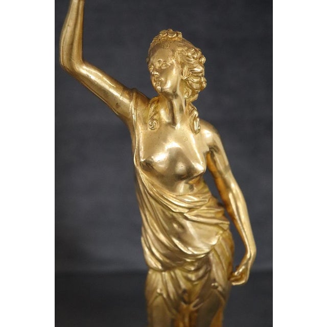 20th century pair of gilded bronze sculptures on a circular alabaster base. Two female figures of classic taste,...