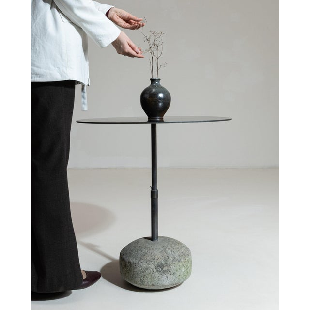Round stone-base side table in Deep Charcoal Grey. Its deep charcoal grey finish sets off rounded natural stone base, slim...