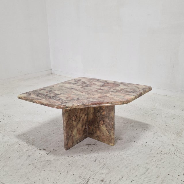 This elegant sculptural side table is crafted entirely from solid marble and originates from Italy. The table features a...