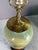 Vintage lamp painted village scene on a vase table lamp with wooden base and brass lid. Working corded electric condition.