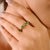 This elegant half eternity band showcases natural pear-cut emeralds totaling 1.27 carats, each measuring approximately 5x4...