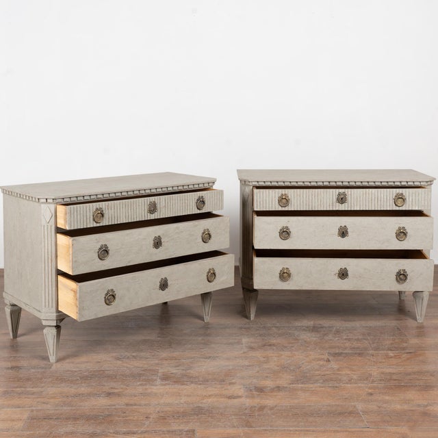 19th-century Swedish pair of pine chests of drawers with a newer professionally applied layered gray painted finish. The...