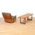 A beautifully crafted Danish Modern coffee table in teak, showcasing clean lines, a warm richly grained top, and elegantly...