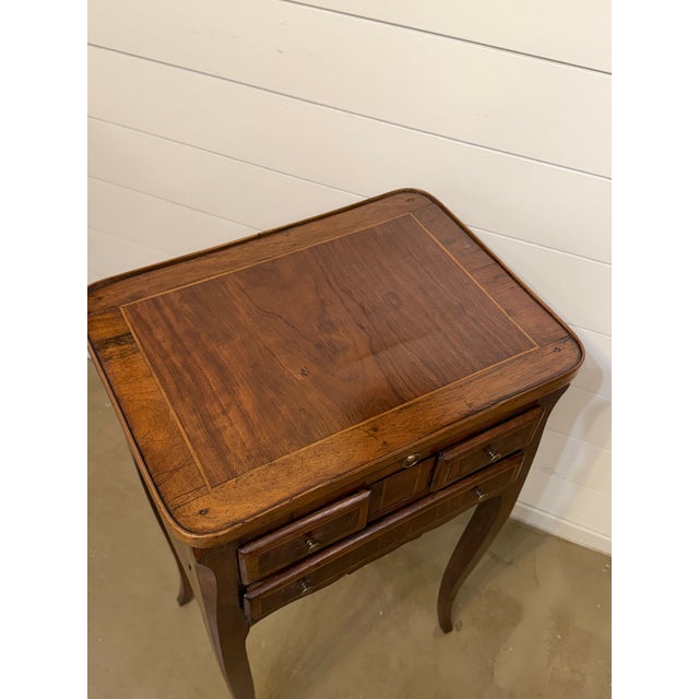 This solid French side table with cabriole legs, inlaid woodwork, and scalloped apron would make such a timeless addition...