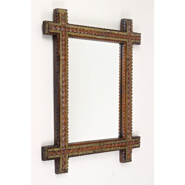Beautiful crafted late 19th century Tramp Art mirror out of Austria. Elaborately made around 1870, this small rustic...