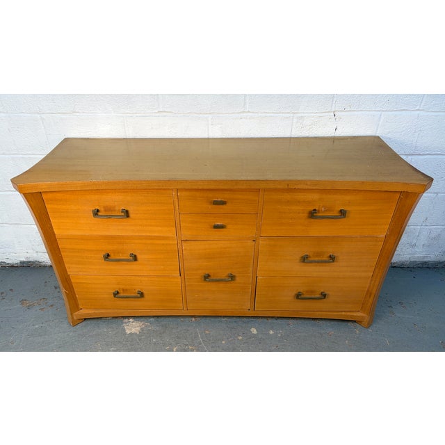 Add timeless character and sophistication to your space with this stunning vintage mid-century dresser. Featuring clean,...