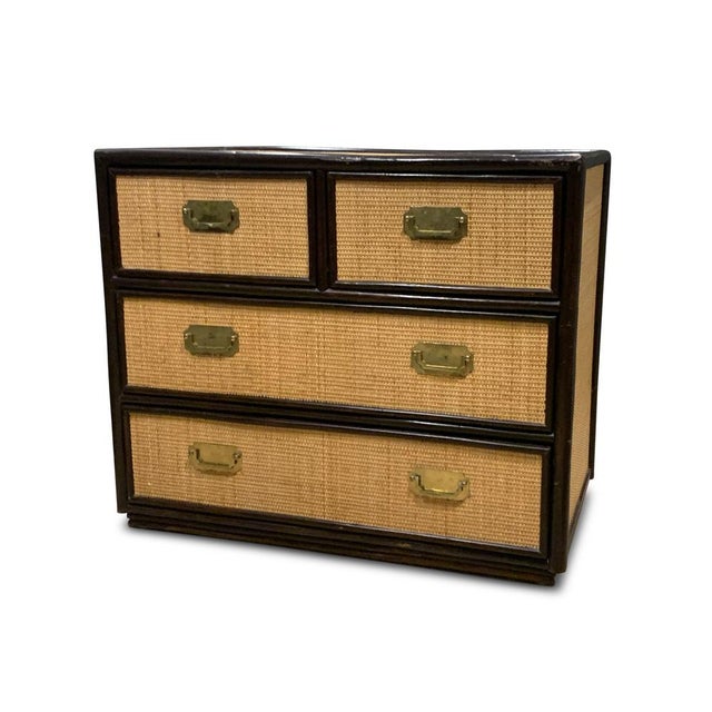 Mid-century organic rattan five drawer chest. ebonised wood, frames the chest and the glazed top. Finishes the item for...
