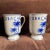 These vintage Delft handpainted Delfleur mugs with Curacao motif have an unusual footed shape and are in excellent...