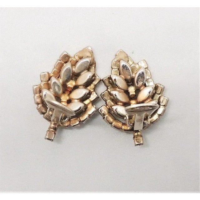 This is part of Chairish’s Costume Jewelry assortment. 1950s goldtone prong set marquise and baguette faux-citrine with...