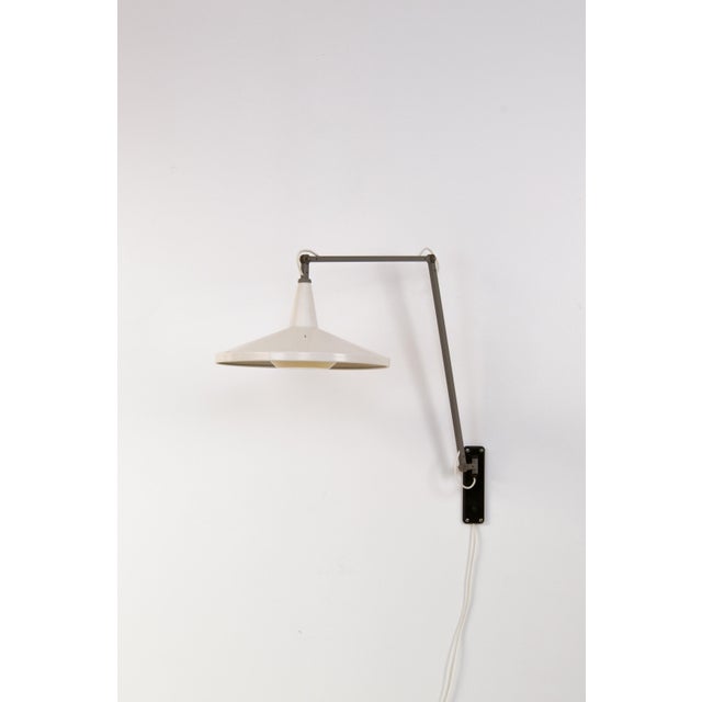 A rare ‘Panama’ wall lamp, designed by Wim Rietveld for Gispen in the 1950s. The lamp consists of a white lacquered...