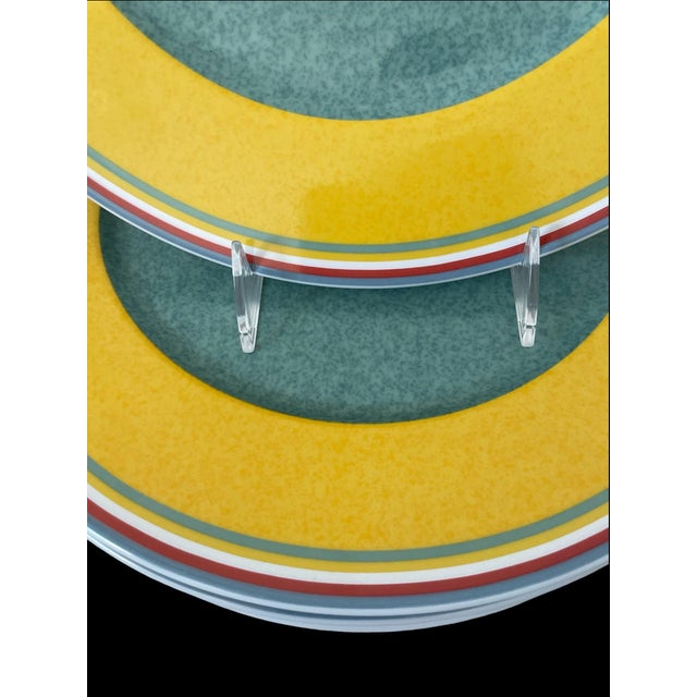 The Beala by Villeroy & Boch Chop/Serving or buffet Plates Set includes six round bone china plates with a multi-color...