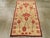 A vintage Turkish Anatolian throw rug. The old ivory ground displays a doubled module, each comprising five pink stylized...