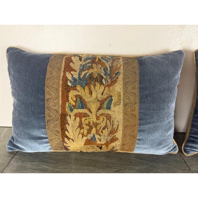 A richly textured pair of decorative pillows created from fragments of 18th century French tapestry, thoughtfully...