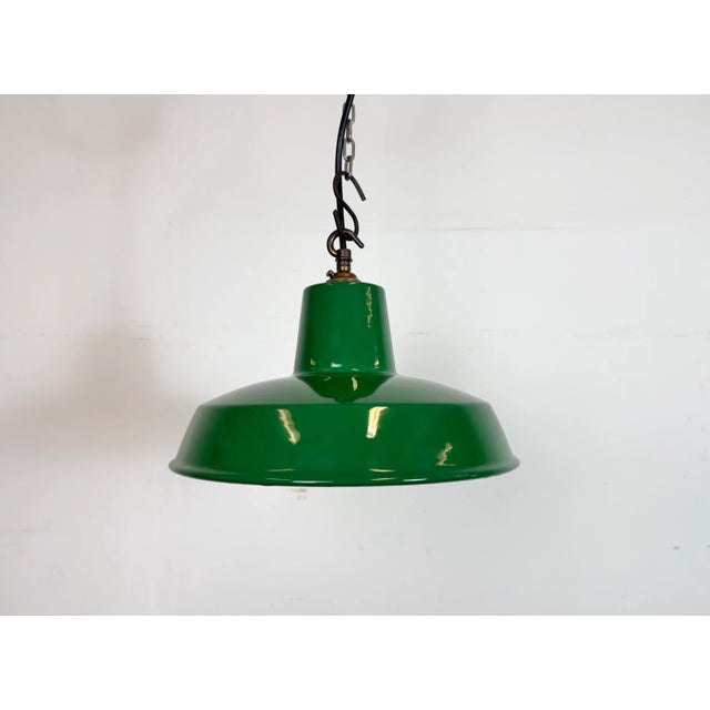 Industrial green enamel factory pendant light made in United Kingdom during the 1960s. White enamel inside the shade....