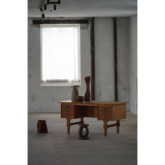 An elegant freestanding writing desk designed by Danish designer Henning Kjærnulf in the 1950s. Crafted in rich oak, the...