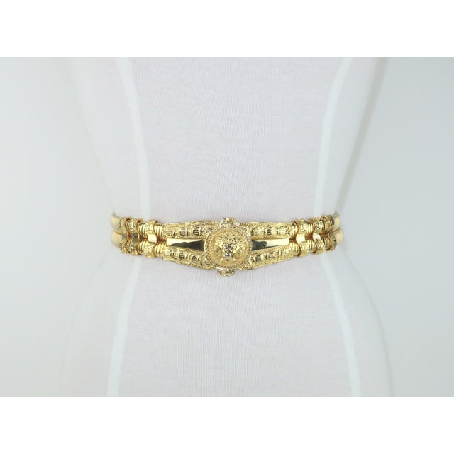 Judith Leiber's stylish spin on a classic Roman gladiator belt with a lion head motif and a heavy gilded look. The buckle...