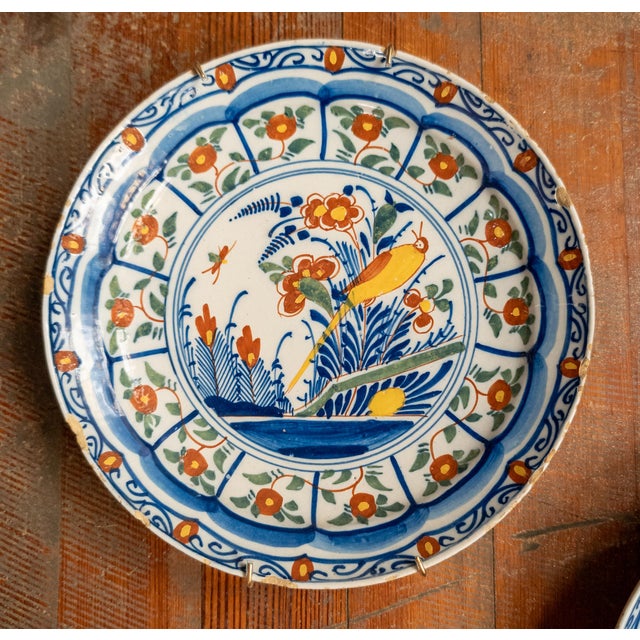 We are selling this nice decorative and colorful pair of Dutch Delft plates. The faience plates have vibrant colors in...