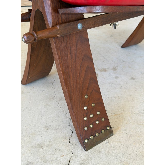 A wonderfully sculptural vintage stool inspired by traditional camel saddle forms, featuring hand-carved camel heads at...