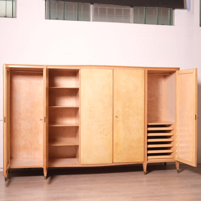 Beautiful six-door wooden wardrobe, originally designed and made in the 1950s, attributed to Paola Buffa. Elegantly shaped...