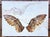 In "Flight II," wings take center stage, rendered in rich, textured encaustic layers that evoke a sense of movement and...