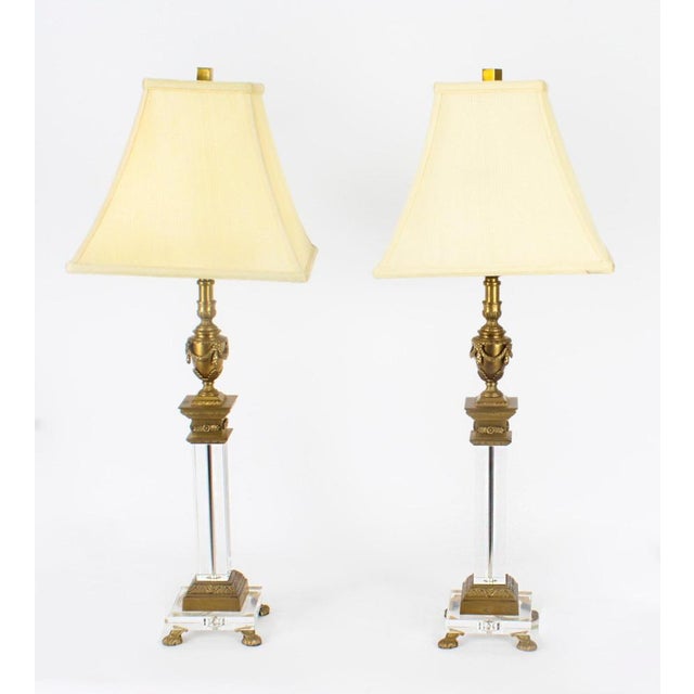 This is an impressive vintage pair of ormolu and glass classical corinthian column & urn table lamp, circa Mid 20th...