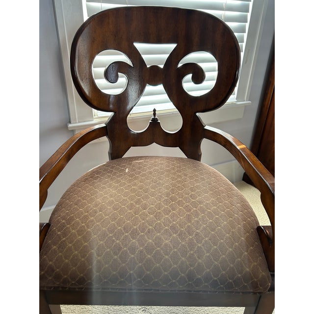 Ornately carved Biedermeier-style wood armchair with upholstered seat.