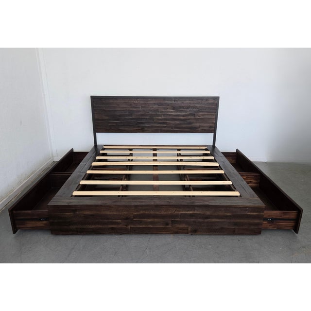 This is the Logan King Storage Bed by West Elm, a modern platform bed that blends form and function with clean lines, rich...