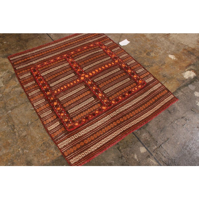 Hand woven circa 1980, this vintage Kilim enjoys a play of embroidery and flat weave technique, creating the subtle high-...