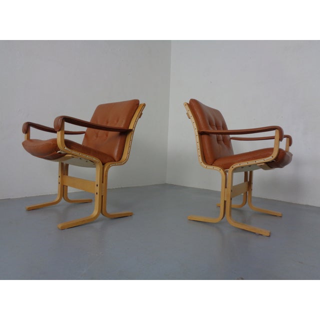 Pair of Siesta armchairs in cognac-colored leather. This piece has an attribution mark, I am sure that it is completely...