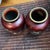 These are a pair of Japanese ginbari cloisonné vases, likely by the Sato company. The vases feature a deep "pigeon blood"...
